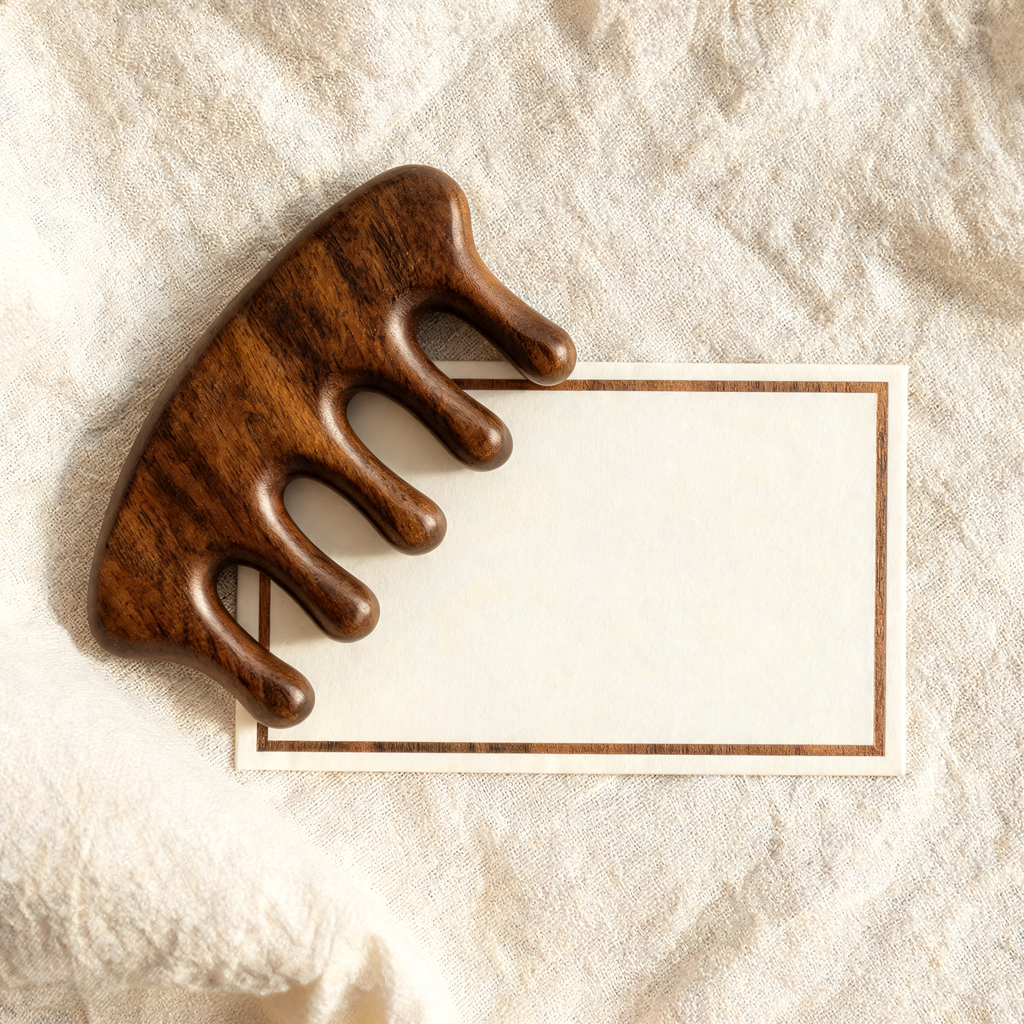 Wooden scalp massage comb with VIP membership card on cream linen