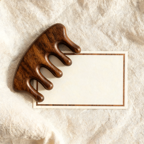 Wooden scalp massage comb with VIP membership card on cream linen
